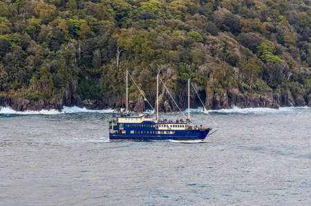 Milford Sound, New Zealand - November 14, 2014: The Milford Mariner Ship cruising in Milford Sound Fjord, New Zealand. This fiord is considered as one of the most scenic places in the world.のeditorial素材