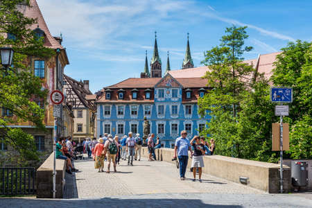 Bamberg, Germany - May 22, 2016: People seating and passing by bridge in downtown of Bamberg, Upper Franconia, Bavaria, Germany.のeditorial素材
