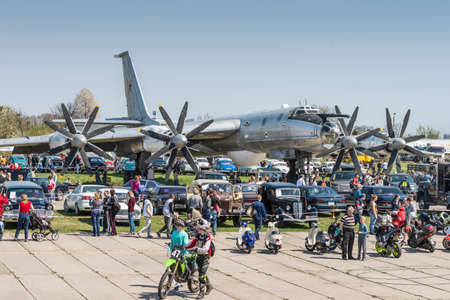 Kyiv, Ukraine - April 26, 2015: Strategic bomber Tu-95 Bear is in the State Museum of Aviation.People walk viewing the exhibits of the festival "Old Car Fest 2015" at April 26, 2015 in Kiev, Ukraine.のeditorial素材