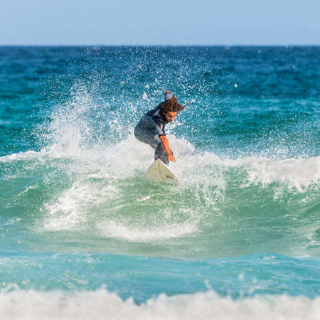 Sydney, Australia - November 26, 2014: A man rides his surfboard towards the shore. Famous Bondi Beach offers a wide range of sports and recreational activities.のeditorial素材