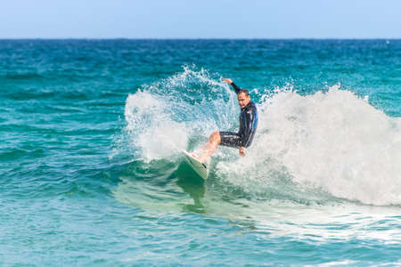Sydney, Australia - November 26, 2014: A man rides his surfboard towards the shore. Famous Bondi Beach offers a wide range of sports and recreational activities.のeditorial素材