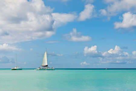 Idyllic and turquoise sea in Palm Beach with boats, Aruba - Antilles, Caribbean.の写真素材