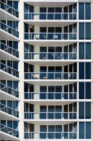 New Modern apartment house - this is a vertical, color photograph of a high rise, Miami Beach apartment building. The detailed shot shows the repetition of balconies.の写真素材