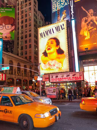 New York, NY, USA - November 20, 2011: Traffic and tourists walk south down Broadway into Times Square after dark to see the lights, go to the theater, and eat. Huge billboards on the buildings along Seventh Avenue and Broadway advertise theater shows, inのeditorial素材