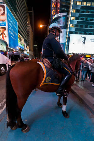 New York, USA - November 20, 2011: Mounted NYPD Policemen on horses, on duty at night near Times Square, Manhattan, New York, USA.のeditorial素材