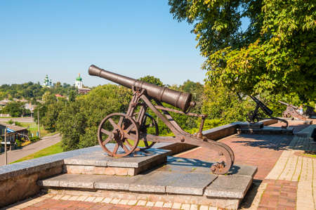 Old cast-iron cannon stands on a pedestal in a city park in Chernigov, Ukraine. Chernihiv is one of oldest cities of Kievan Rus.の写真素材