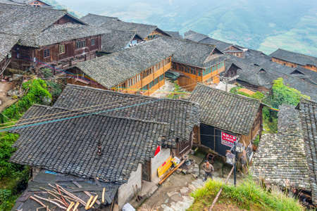 Longsheng, China - October 19, 2013: Traditional chinese Long Ji minority village wooden houses in cloudy weather. There are two Zhuang ethnic group villages live in the mountain â Ping An Village and Long Ji village at Longsheng, Guangxi province, Chinのeditorial素材