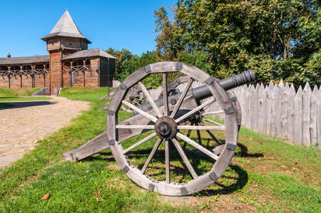 Old Cossack cannons installed on wooden carriages are still on duty in the ancient wooden citadel in Baturin, Ukraine.の写真素材