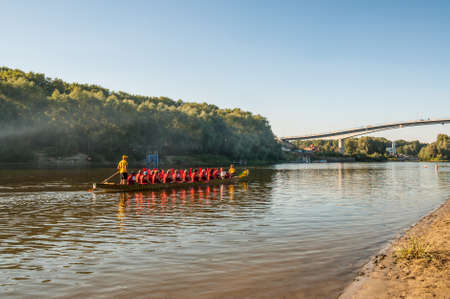 Chernihiv, Ukraine - August 28, 2016: Sunset landscape with tourists on a kayak on the Desna river in the vicinity of Chernihiv, Ukraine.のeditorial素材