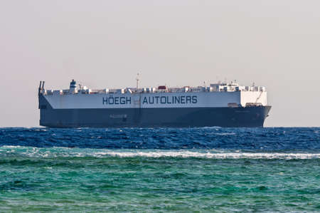 Sharm El Sheikh, Egypt - November 28, 2010: Vehicles Carrier vessel Hoegh Triton sails along the...