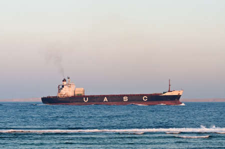 Sharm El Sheikh, Egypt - November 21, 2010: Container ship Hammurabi (almost empty) sails along the shore of the Red Sea near Sharm El Sheikh, Egypt at November 21, 2010. Type of vessel: Container Ship. Flag: Kuwait.のeditorial素材