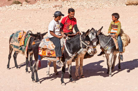 Petra, Jordan - November 20, 2010: Arab guides prepared donkeys and waiting for transportation of tourists around the Ancient City of Petra, Jordanのeditorial素材