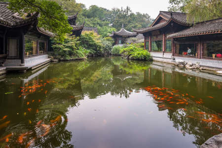 Hangzhou, China - October 24, 2013: Pond and fish koi in classic chinese garden, Hangzhou, China.のeditorial素材