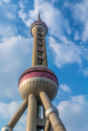 Shanghai, China - October 26, 2013: Oriental Pearl Tower with cloudy blue sky background, Shanghai,...