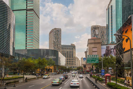 Shanghai, China - October 25, 2013: Traffic on the Huaihai Street in central Shanghai beside upmarket shopping mall in China.のeditorial素材