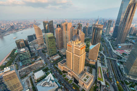 Shanghai, China - October 26, 2013: Wide angle view from the Oriental Pearl TV Tower to Shanghai Cityscape aside the Huangpu river at sunset, China.のeditorial素材