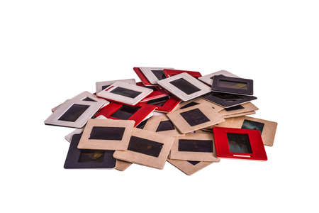 35 mm mounted film slides into the plastic and cardboard different colored frames isolated on white background, cliping path embeddedの写真素材