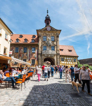 Bamberg, Germany - May 22, 2016: Tourists at historical streets of Bamberg in Bavaria, Germany. The historic town hall was built in the 14th century.のeditorial素材