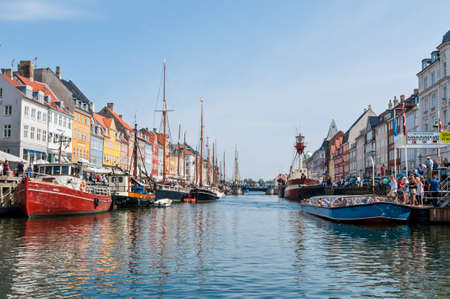 Copenhagen, Denmark - August 5, 2010: People visiting the Nyhave (meaning New Harbour) 17th century...