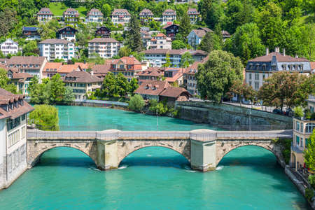 Bern, Switzerland - May 26, 2016: View of the Aare River, bridge and houses with tiled rooftops at Bern, Switzerlandのeditorial素材