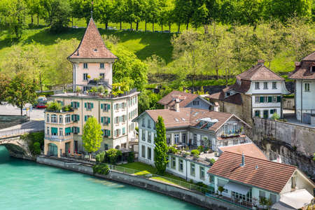 Bern, Switzerland - May 26, 2016: Houses lining the banks of the Aare river in Bern (Unesco Heritage), the capital of Switzerland.のeditorial素材