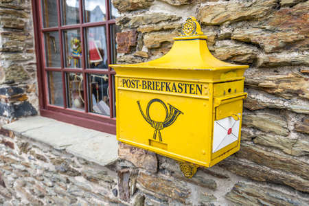 Marksburg, Germany - May 23, 2016: Retro yellow public post mailbox on a wall in Marksburg, Braubach, Germany.のeditorial素材