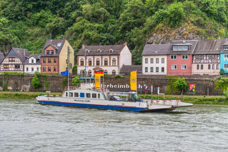 Niederheimbach, Germany - May 23, 2016: Ferry on the Rhine River near Niederheimbach in cloudy weather, Rhine Valley, UNESCO World Heritage Site, Germany.のeditorial素材