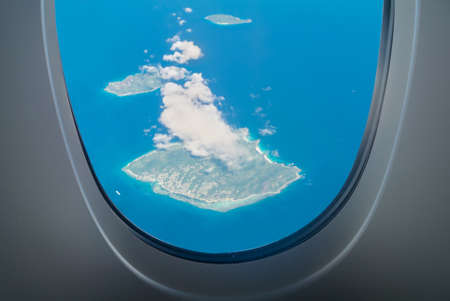 La Digue Island aerial view through aircraft windows in Seychelles - archipelago and country in the Indian Ocean. Visible Felicite and Marianne Islands.の写真素材