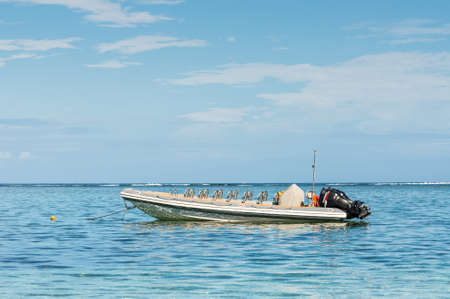 Le Morne, Mauritius - December 11, 2015: A sunny day with speed boat on the Le Morne Beach, one of the finest beaches in Mauritius and the site of many tourism facilities.のeditorial素材