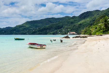 Anse Royale, Mahe Island, Seychelles - December 15, 2015: Seychelles paradise, the Anse Royale beach of Mahe with white sand, turquoise sea and coconut trees. Some people enjoying the Beach, Mahe Island, Seychelles.のeditorial素材