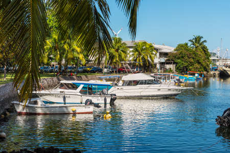 Victoria, Mahe, Seychelles - December 16, 2015: Boats resting at the colourful palm-lined Victoria Harbour in Mahe Island, Seychelles, Indian Ocean, Africa.のeditorial素材