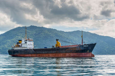 Hell-Ville, Madagascar - December 19, 2015: General Cargo Ship Muneera (formerly known as Semlow) anchored at Hell-Ville, Nosy Be Island, Madagascar.のeditorial素材