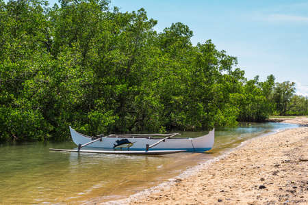 Ambatozavavy, Nosy Be, Madagascar - December 19, 2015: Traditional wood pirogue with outrigger on...