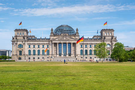 Berlin, Germany - May 28, 2017: Reichstag building, German Parliament, people enjoying a spring day. The dedication Dem deutschen Volke, meaning To the German people, can be seen on the frieze.のeditorial素材