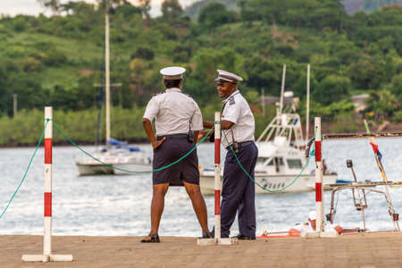 Hell-Ville, Madagascar - December 19, 2015: Malagasy Police officers are talking at Hell-Ville port, Nosy Be Island, Madagascar.のeditorial素材