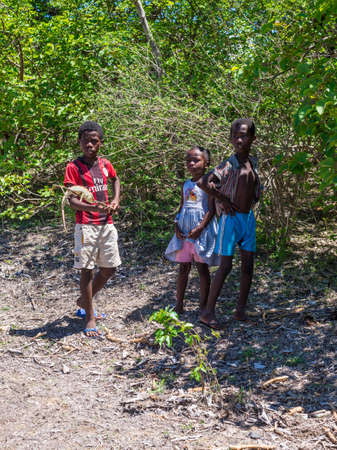 Antsiranana, Madagascar - December 20, 2015: Malagasy children playing with a chameleon near Antsiranana (Diego Suarez), Madagascar, Africa.のeditorial素材