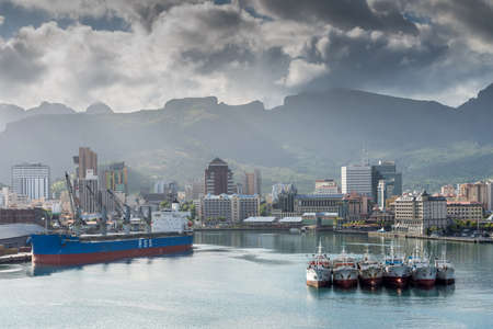 Port Louis, Mauritius - December 25, 2015: Port Louis cityscape Mauritius. Ships in the harbor in foreground. The city is the country's economic, cultural, political centre and most populous city.のeditorial素材