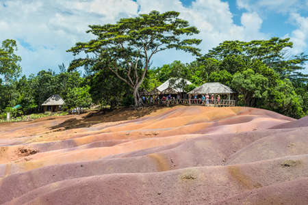 Chamarel, Mauritius - December 26, 2015: People watching for main sight of Mauritius - Seven Coloured Earth in Mauritius, Chamarel nature reserve. Green forest behind and blue cloudy sky.のeditorial素材