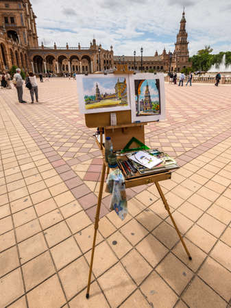 Seville, Spain - May 20, 2014: Artists easel and artwork set up on the Spain Square (Plaza de Espana), Seville, Spain.のeditorial素材