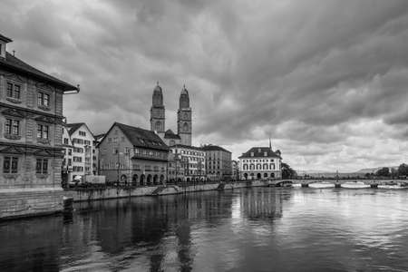 Zurich, Switzerland - May 24, 2016: Architecture of Zurich in overcast rainy weather, the largest city in Switzerland and the capital of the canton of Zurich, Switzerland. Limmat river in the foreground. Black and white photography, dramatic sky.のeditorial素材