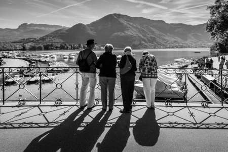 Annecy, France - May 25, 2016: People on the Bridge of love in Annecy, France. Annecy is a commune in the Haute Savoie department of the Rhone-Alpes region in south-eastern France. Black and white photography.のeditorial素材
