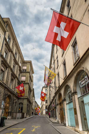 Geneva, Switzerland - May 25, 2016: Swiss Flag and Flag of Geneva on the facade building in Geneva, Switzerland.のeditorial素材