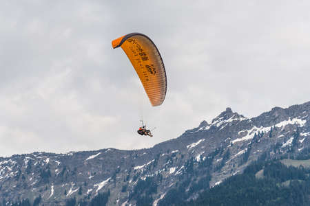 Interlaken, Switzerland - May 26, 2016: Tandem paragliding flights over the Swiss Alps in Interlaken, Switzerland.のeditorial素材