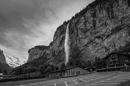 Lauterbrunnen, Switzerland - May 26, 2016:  Staubbach waterfalls in a overcast day in Lauterbrunnen Valley and Swiss Alps, Switzerland. Black and white vintage style.のeditorial素材