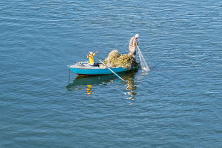 Ismailia, Egypt - November 5, 2017: Fishermen in wooden boat on the Suez Canal in Egypt.のeditorial素材