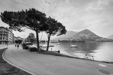 Lugano, Switzerland - May 28, 2016: View of the Embankment of lake Lugano, Lugano. Switzerland, Europe. Black and white photography.のeditorial素材