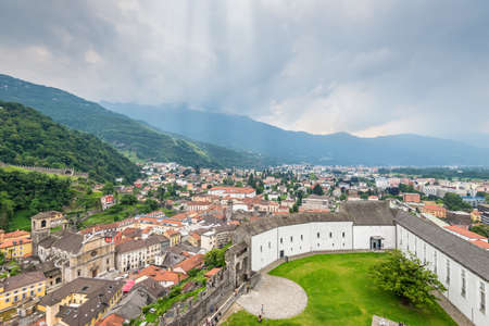 Bellinzona, Switzerland - May 28, 2016: Bellinzona cityscape view from castle under cloudy sky in Switzerland, surrounding with high Alps mountains.のeditorial素材
