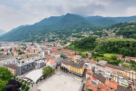 Bellinzona, Switzerland - May 28, 2016: Bellinzona cityscape view from castle under cloudy sky in Switzerland, surrounding with high Alps mountains.のeditorial素材