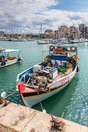 Heraklion, Greece - November 2, 2017: Fishing boat and a fisherman with a dog in the port of Heraklion, Crete, Greece.のeditorial素材