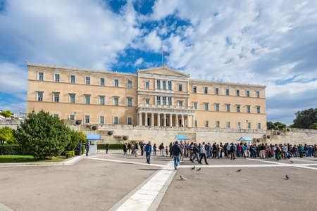 Athens, Greece - November 1, 2017: Tourists in front of the building of Greek parliament in Athens,...